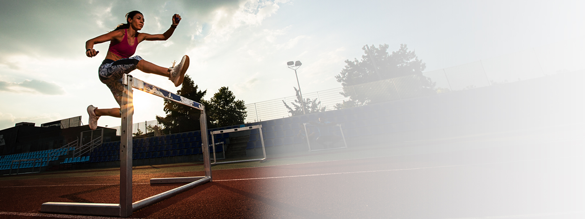 woman jumping hurdle